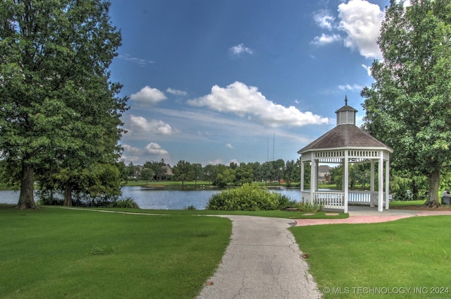 view of home's community with a water view, a yard, and a gazebo