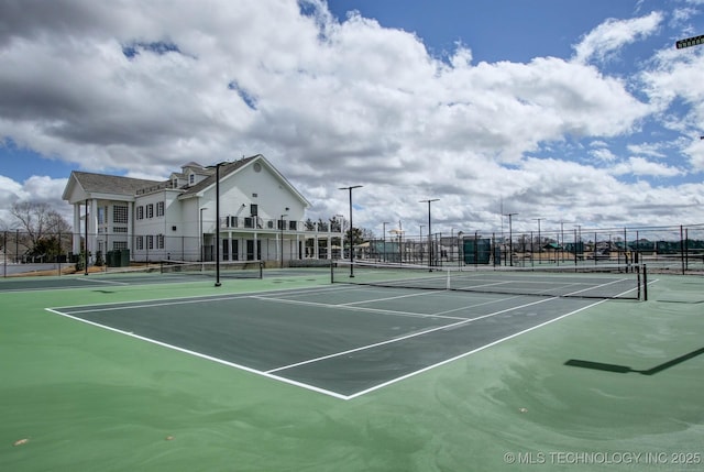 view of tennis court with fence