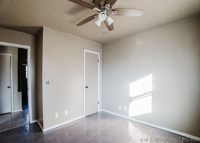 unfurnished bedroom with ceiling fan and a textured ceiling