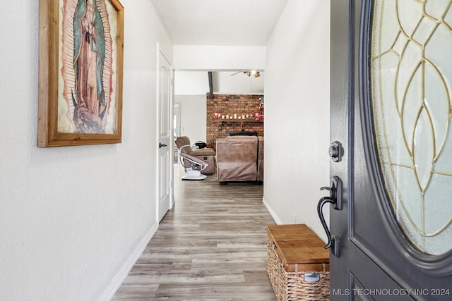 hallway with light hardwood / wood-style floors