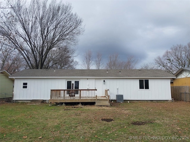 rear view of house featuring central AC, a yard, and a deck