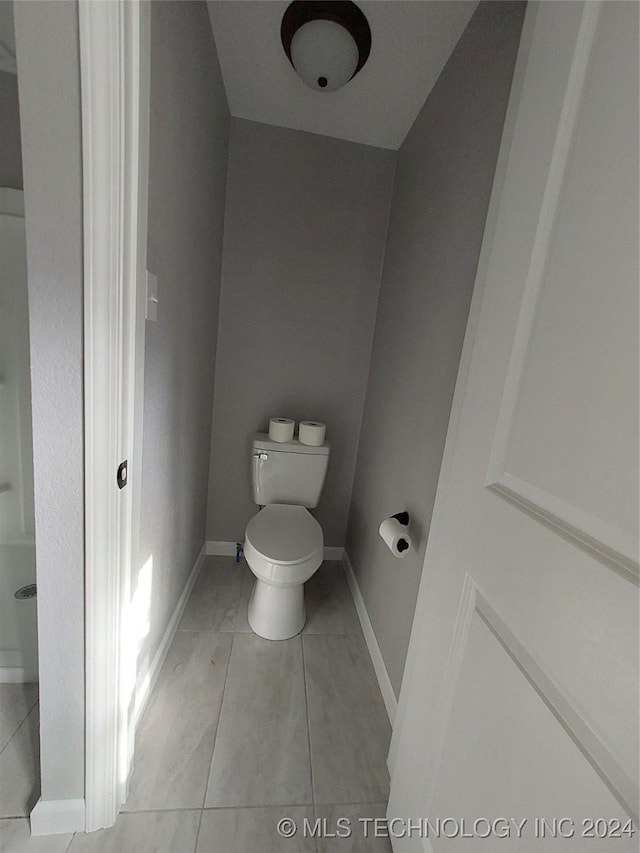 bathroom featuring tile patterned flooring and toilet