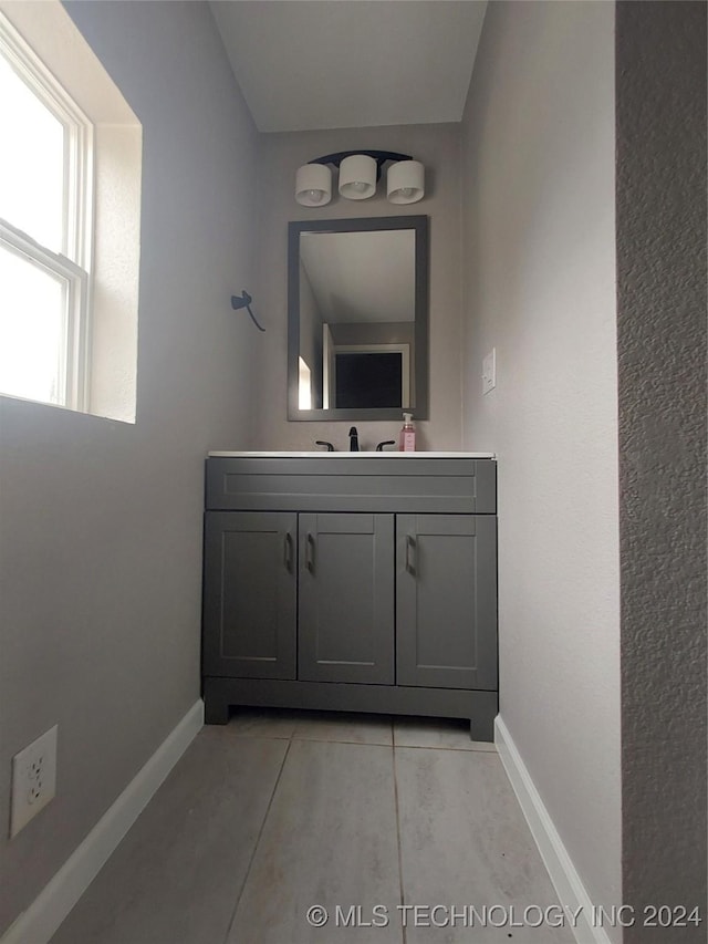 bathroom with tile patterned floors and vanity