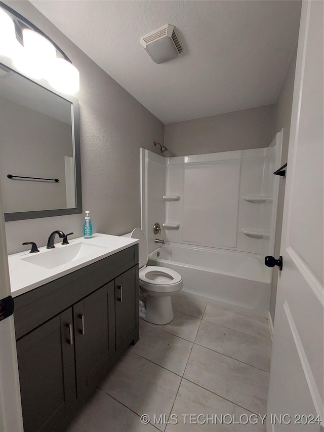 full bathroom featuring vanity, tile patterned flooring, toilet, a textured ceiling, and tub / shower combination