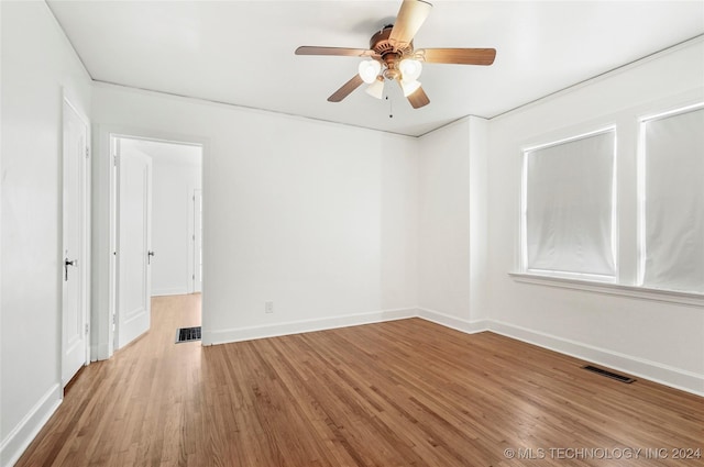 unfurnished room with ceiling fan and hardwood / wood-style flooring