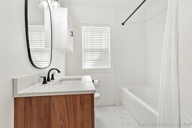 full bathroom with vanity, toilet, and tiled shower / bath combo