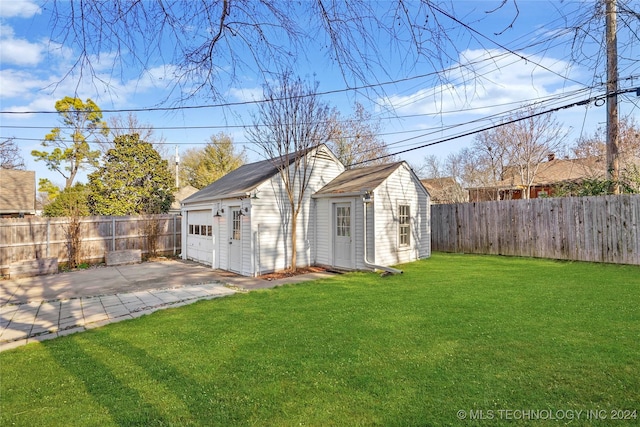 view of outbuilding with a yard and a garage