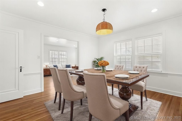 dining room with ornamental molding and dark wood-type flooring