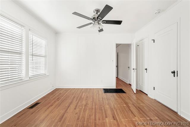 unfurnished bedroom featuring ceiling fan and hardwood / wood-style floors