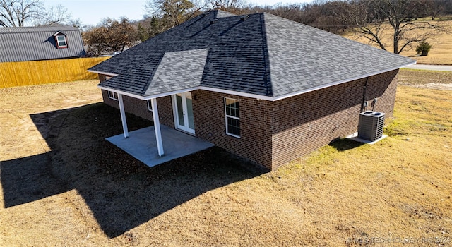 view of side of property with cooling unit and a patio area