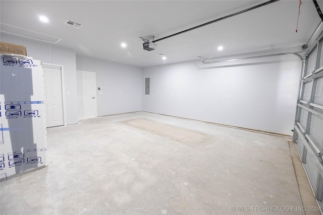 garage featuring a garage door opener and electric panel