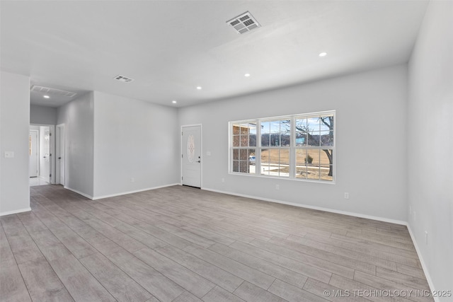 spare room with light hardwood / wood-style flooring