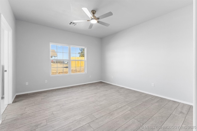 spare room featuring ceiling fan and light hardwood / wood-style floors