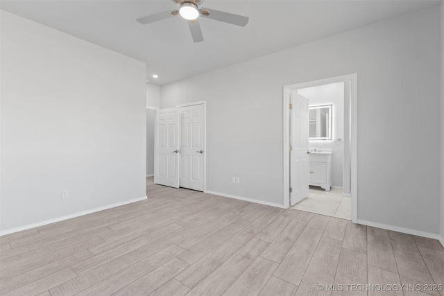 unfurnished bedroom with ensuite bath, light hardwood / wood-style flooring, a closet, and ceiling fan