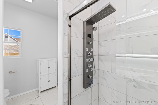 bathroom with toilet and a shower with shower door