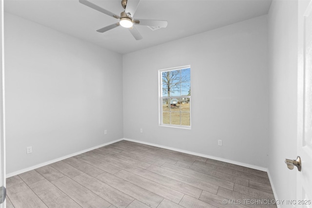 empty room with ceiling fan and light hardwood / wood-style floors