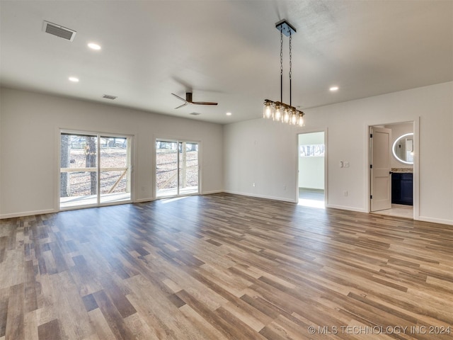 unfurnished living room with ceiling fan and light hardwood / wood-style flooring