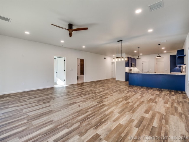 unfurnished living room with light wood-type flooring and ceiling fan