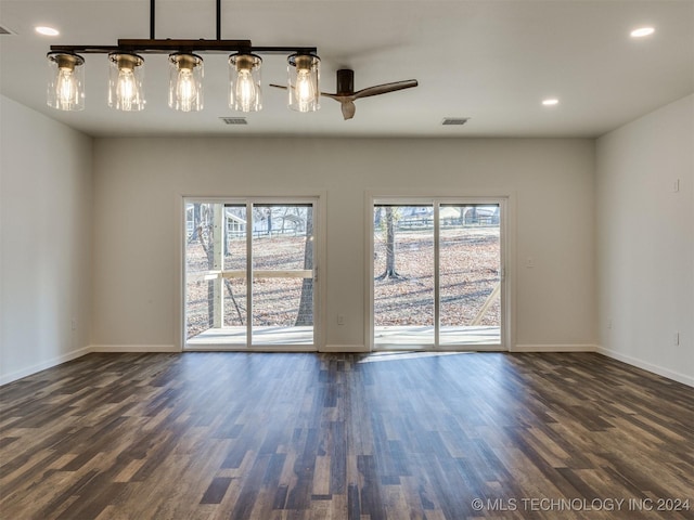 spare room featuring ceiling fan and dark hardwood / wood-style flooring