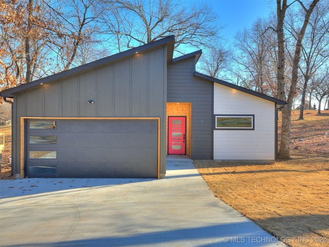 contemporary house featuring an outbuilding and a garage