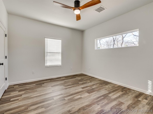 unfurnished room with ceiling fan and hardwood / wood-style floors