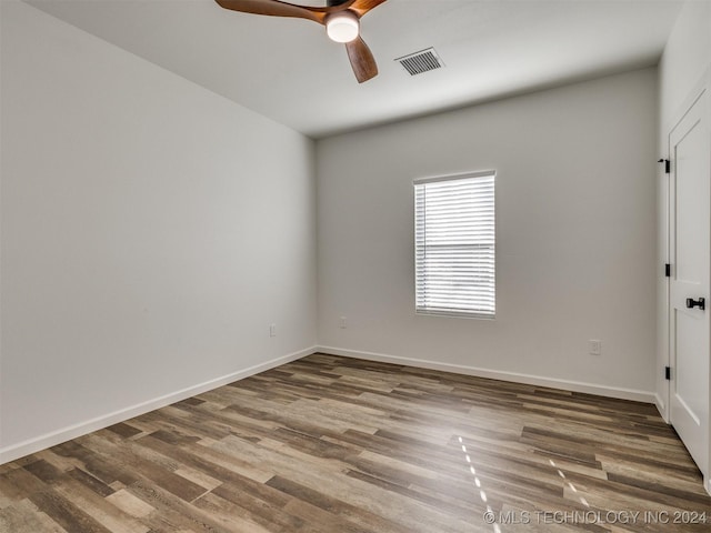 empty room with hardwood / wood-style floors and ceiling fan