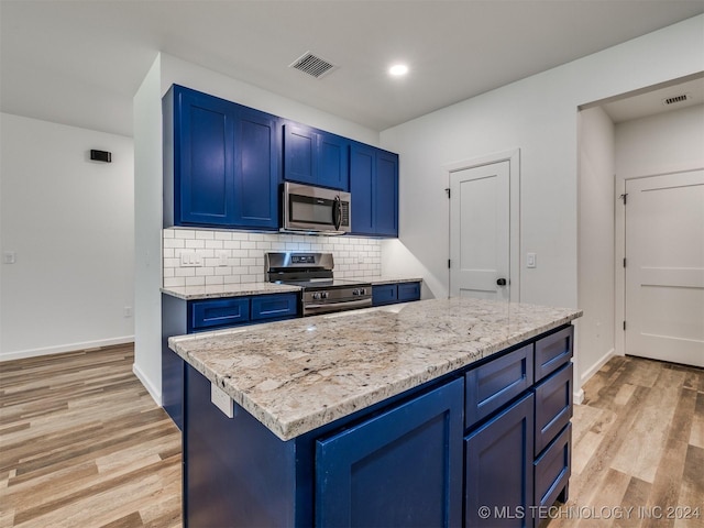 kitchen with decorative backsplash, blue cabinetry, appliances with stainless steel finishes, light hardwood / wood-style floors, and light stone counters