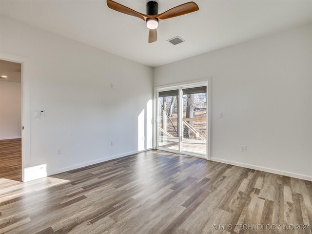 spare room featuring ceiling fan and light hardwood / wood-style flooring