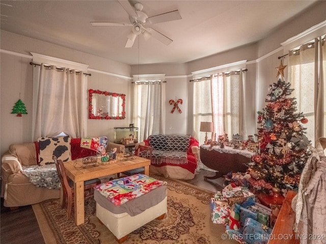 living area featuring hardwood / wood-style floors and ceiling fan