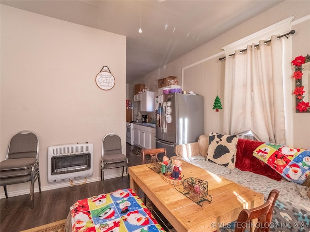 interior space with dark hardwood / wood-style flooring and heating unit