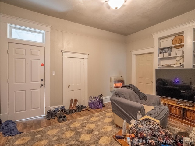 entryway with wood-type flooring and heating unit