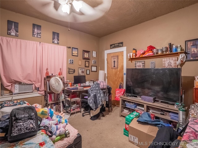 carpeted home office featuring ceiling fan and a textured ceiling