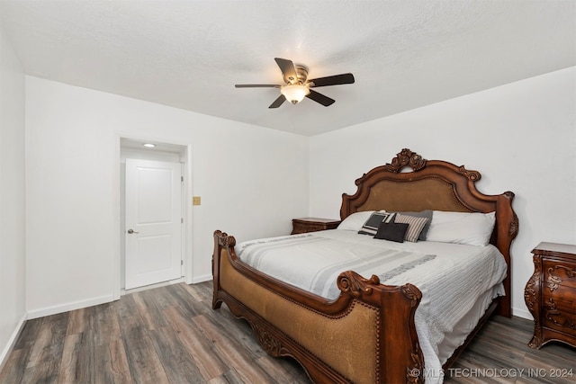 bedroom with ceiling fan and dark wood-type flooring