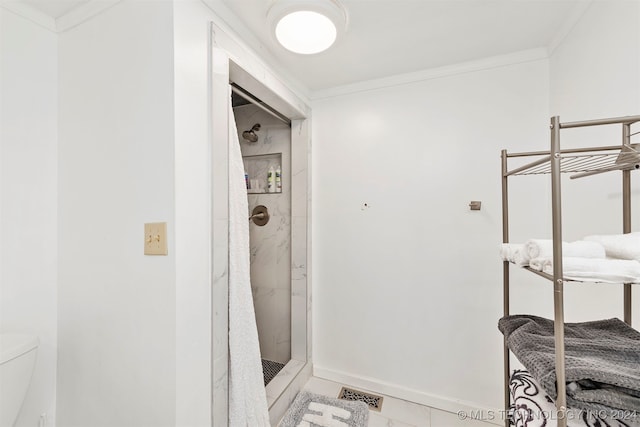 bathroom featuring walk in shower, toilet, tile patterned flooring, and ornamental molding