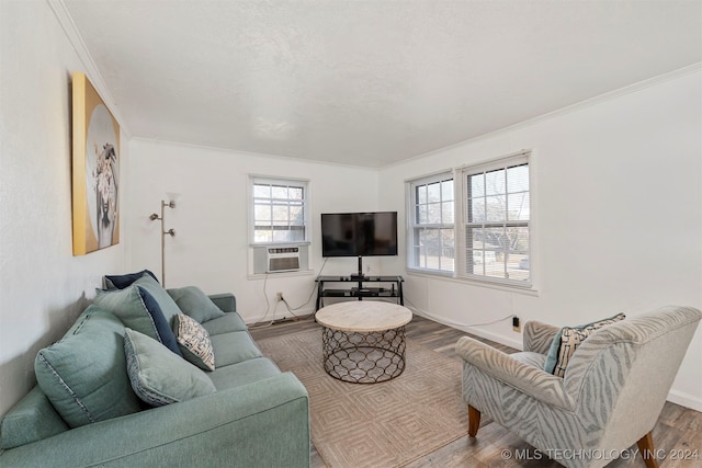 living room featuring a wealth of natural light, hardwood / wood-style floors, cooling unit, and ornamental molding