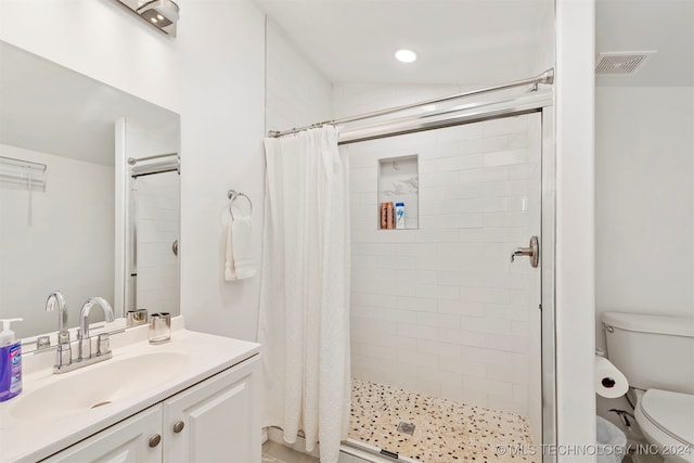 bathroom featuring vanity, curtained shower, toilet, and vaulted ceiling