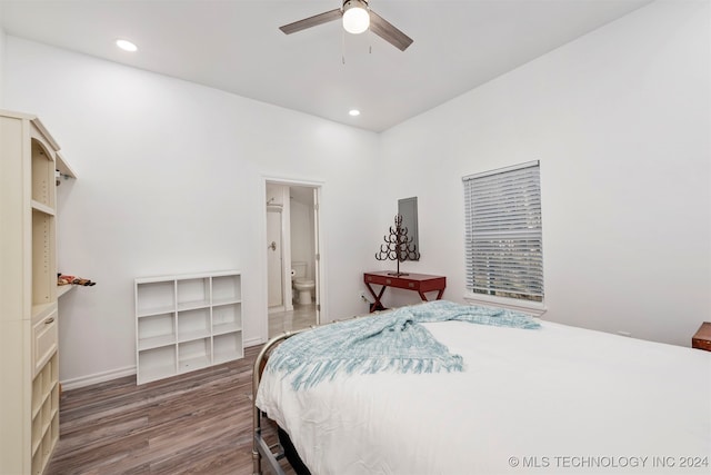 bedroom with ceiling fan, dark wood-type flooring, and ensuite bath