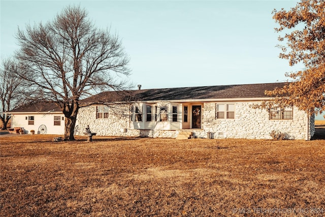 back of house with a lawn