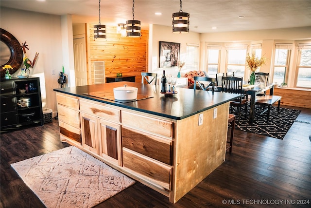 kitchen with dark hardwood / wood-style floors, a center island, decorative light fixtures, and light brown cabinets