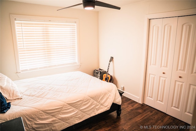 bedroom featuring dark hardwood / wood-style flooring, ceiling fan, and a closet