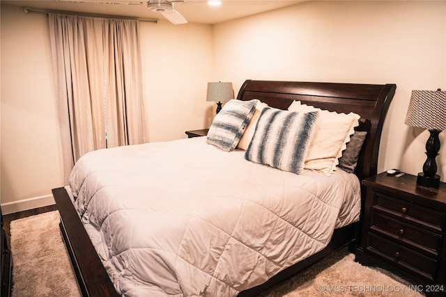 bedroom with ceiling fan and light hardwood / wood-style floors