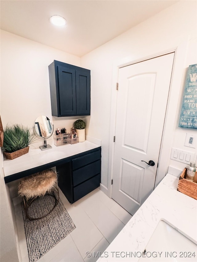 bathroom featuring tile patterned flooring and vanity