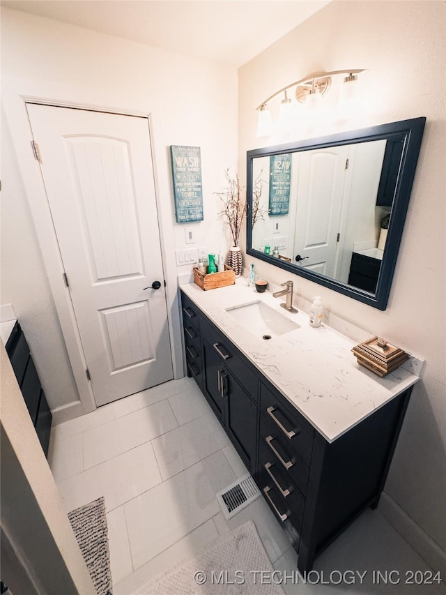 bathroom with tile patterned floors and vanity