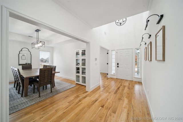 foyer with wood-type flooring and a chandelier