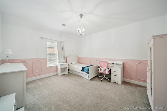 bedroom featuring an inviting chandelier and light carpet