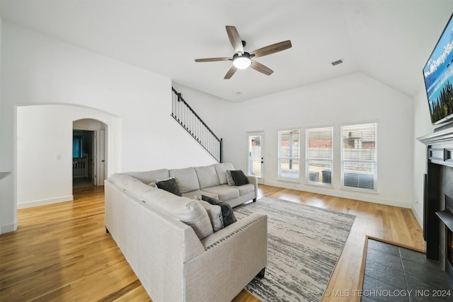 living room with wood-type flooring, vaulted ceiling, and ceiling fan