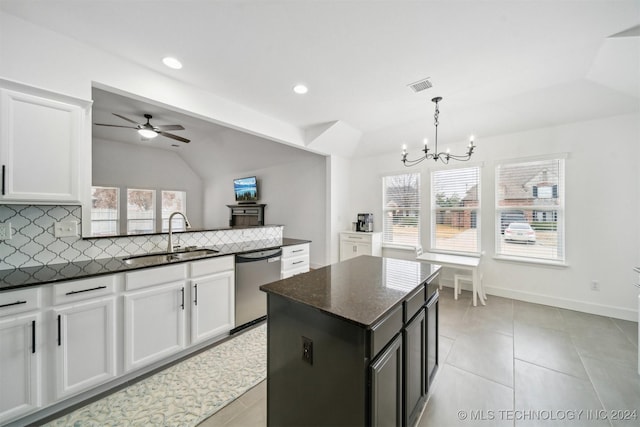 kitchen featuring dishwasher, a kitchen island, white cabinetry, sink, and vaulted ceiling