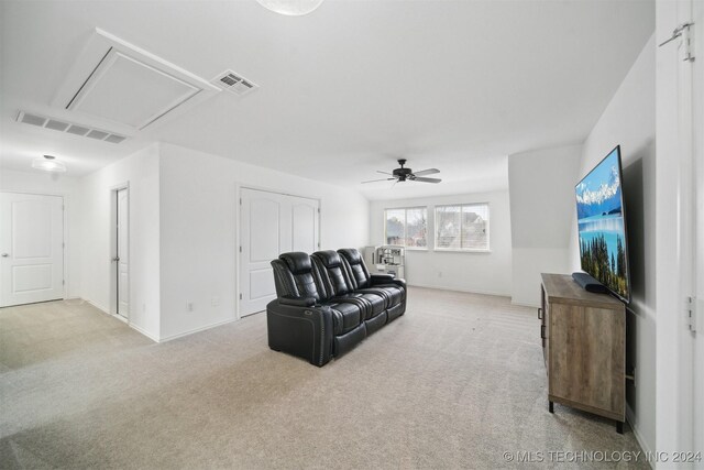 living room with ceiling fan and light carpet