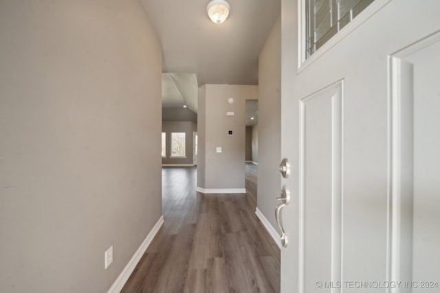 hallway with wood finished floors and baseboards