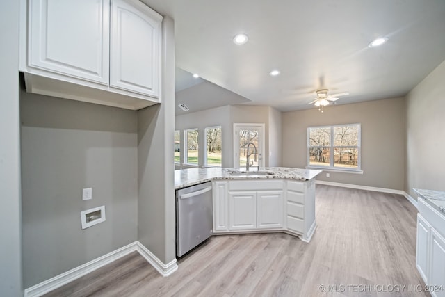 kitchen featuring light stone countertops, white cabinetry, a peninsula, a sink, and dishwasher